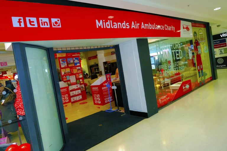 Maac Gloucester There Is A Woman Standing In Front Of A Store With A Red Sign