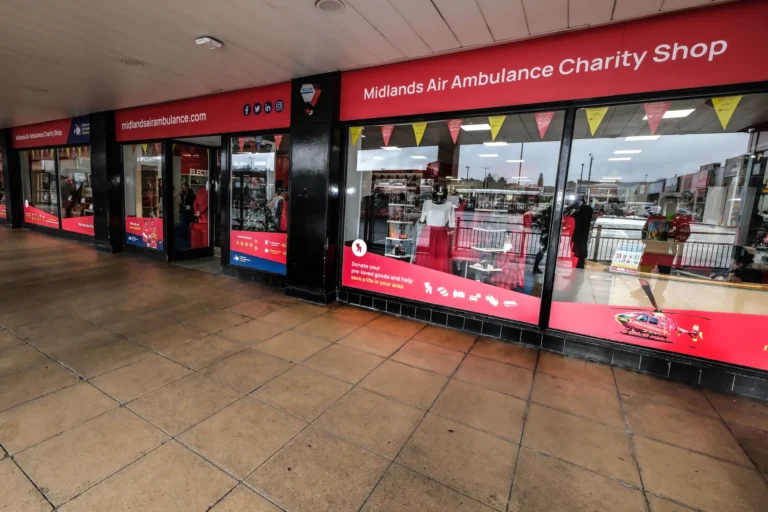 Maac Merry Hill There Is A Store Front With A Red Sign And A Red And White Sign