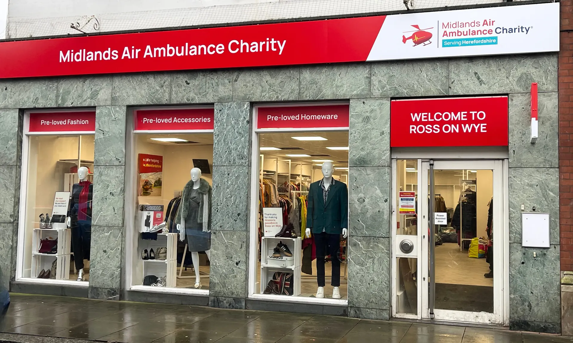 The front of the Midlands Air Ambulance charity shop in Ross-On-Wye, with two male mannequins in the window.