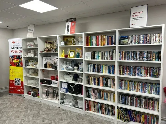 Maac Ross On Wye Shelves Of Books In A Library With A Sign On The Wall