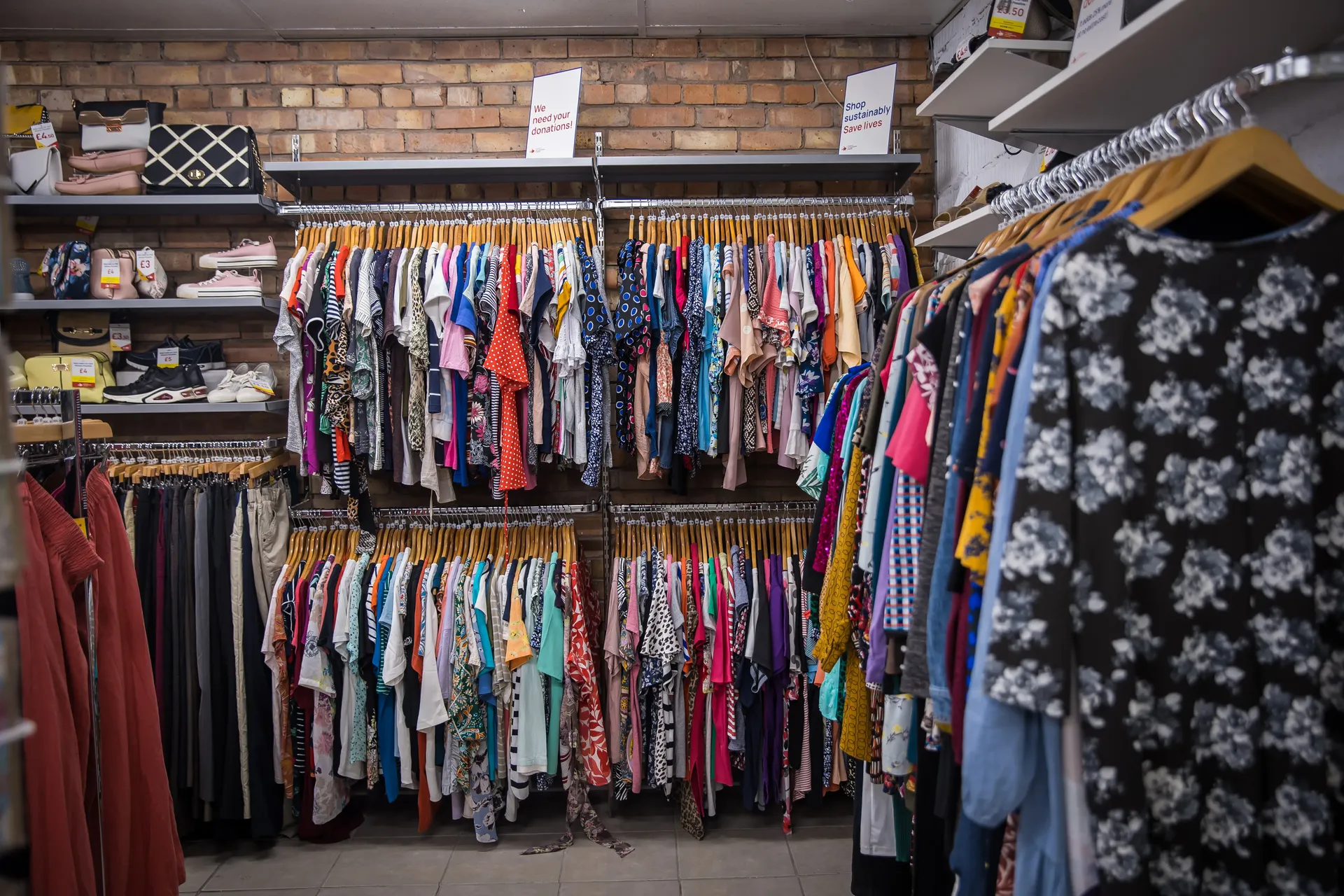 Maac Tipton A Grove Of Clothes Hanging On A Rack In A Clothing Store