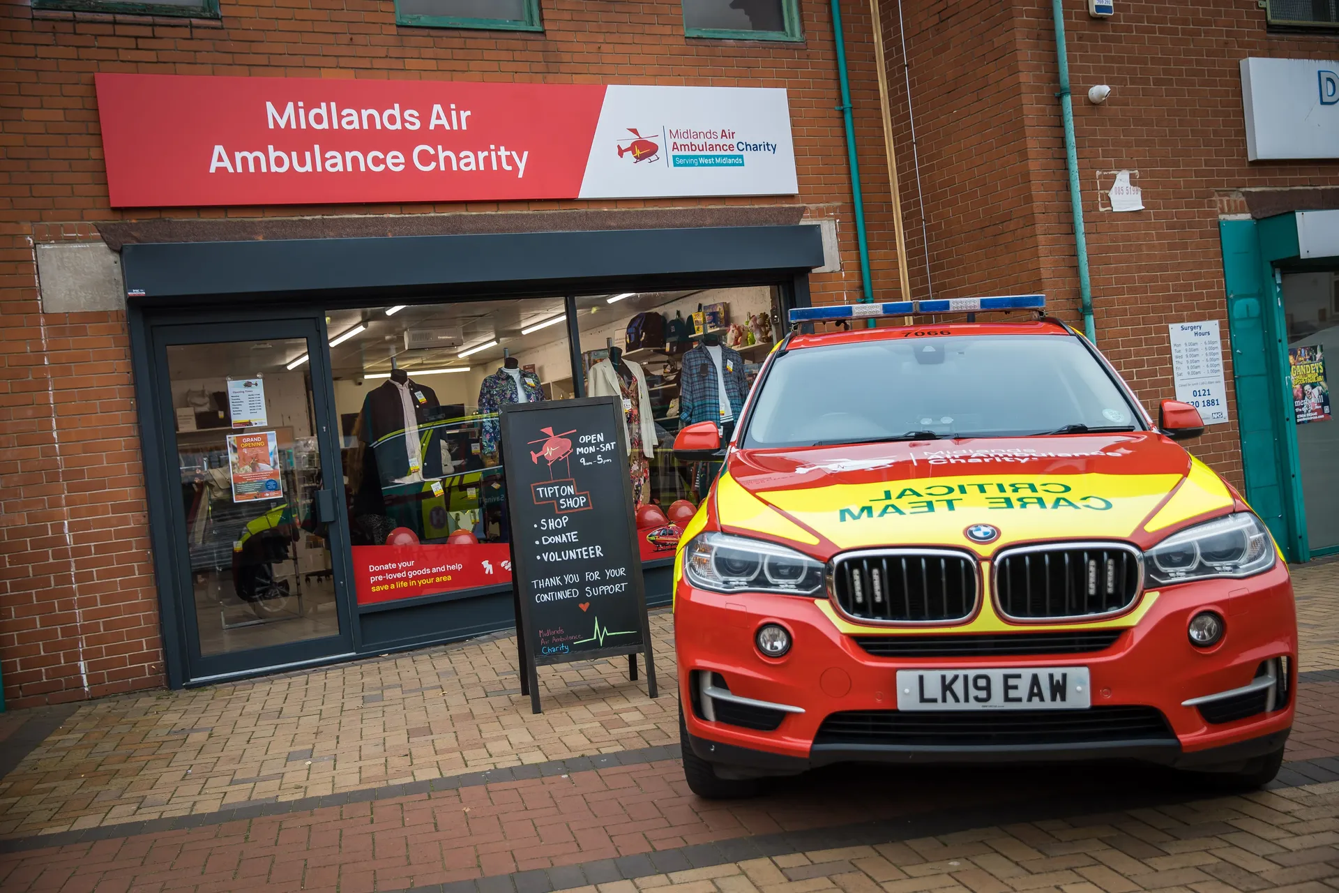 A BMW Air Ambulance car parked in front of the Air Ambulance Charity shop in Tipton.