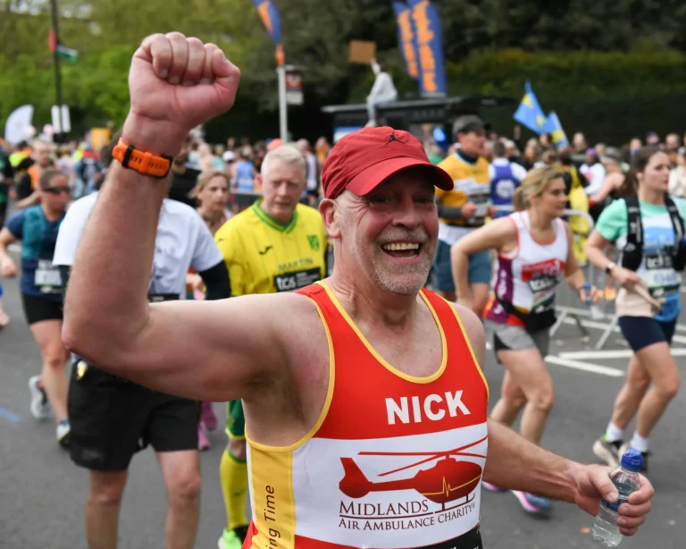 Maac A Man In A Red Hat And A Red Vest Running