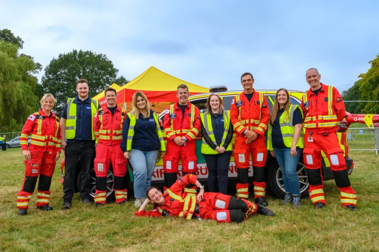 Maac Group Of People In Red And Yellow Safety Gear Posing For A Picture