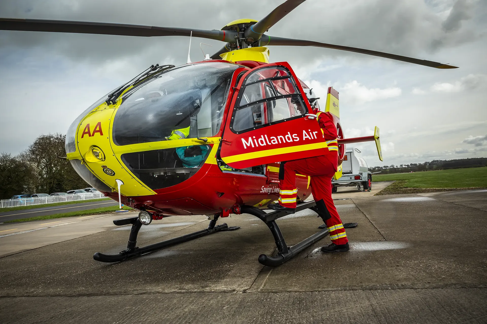 Maac Helicopter Sitting On The Tarmac With A Cloudy Sky