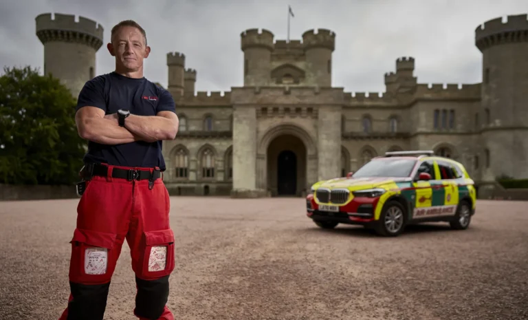 Maac Herefordshire Man Standing In Front Of A Castle With A Car In The Background