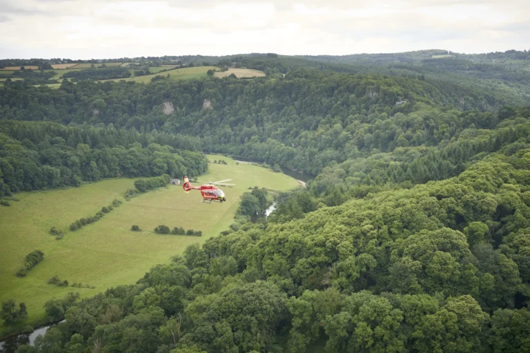 Maac Herefordshire There Is A Helicopter That Is Flying Over A Green Field