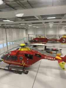 Maac There Are Two Red And Yellow Helicopters Hanging From The Ceiling