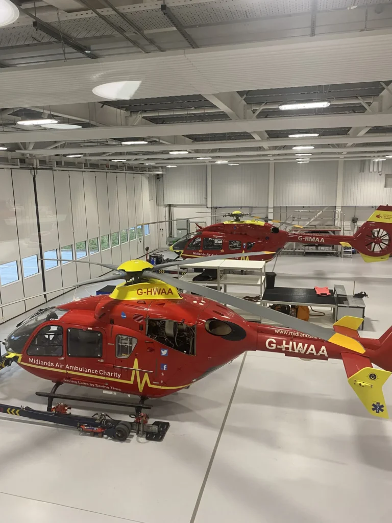 Maac There Are Two Red And Yellow Helicopters Hanging From The Ceiling