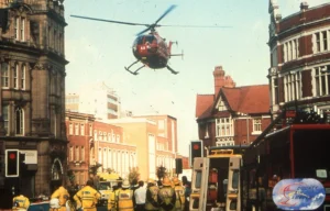 Maac There Is A Helicopter That Is Flying Over A City Street