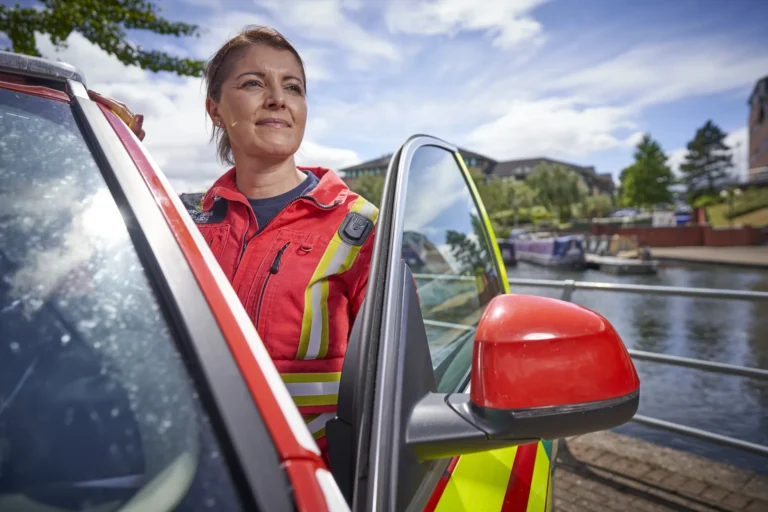 Maac West Midlands There Is A Woman In A Safety Vest Standing Next To A Car