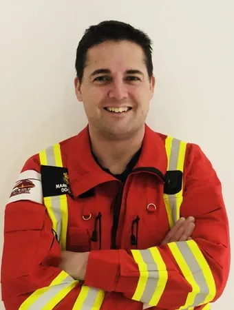 Maac A Close Up Of A Man In A Fireman S Uniform With His Arms Crossed