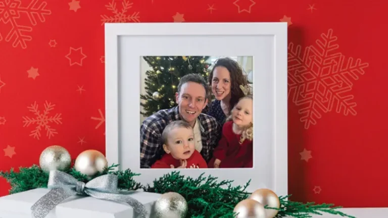 Maac A Close Up Of A Picture Of A Family With Christmas Decorations