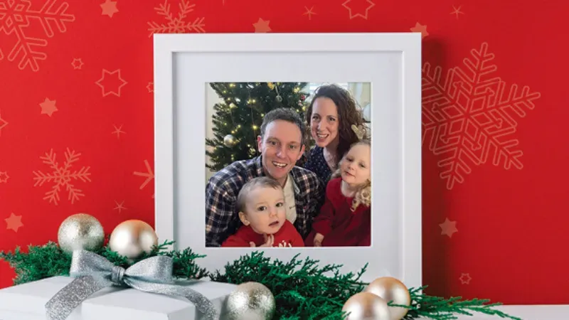 Maac A Close Up Of A Picture Of A Family With Christmas Decorations