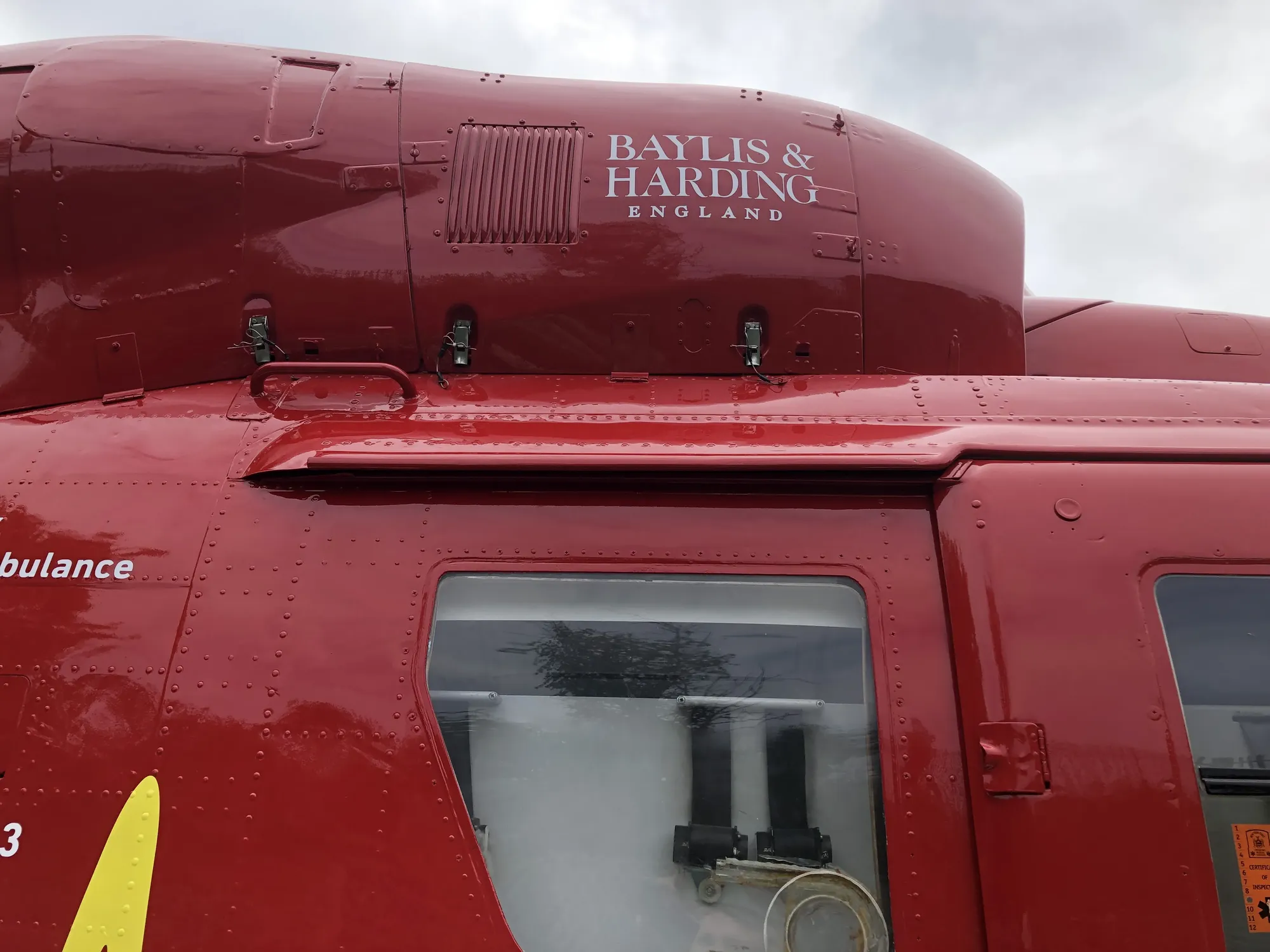 Maac A Close Up Of A Red Helicopter With A Sign On The Side