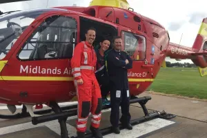 Maac Air Ambulance Crew Standing In Front Of A Helicopter