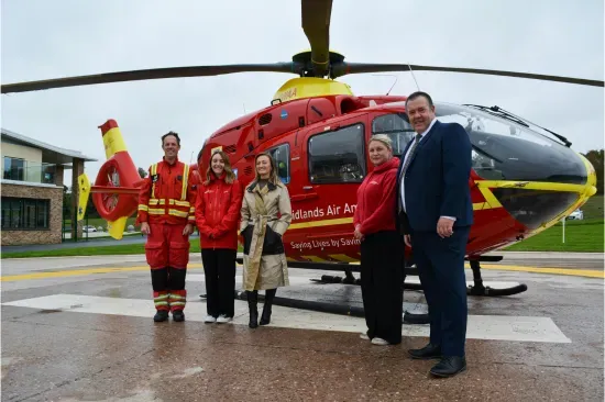 Maac Air Ambulance Crew Standing In Front Of A Helicopter
