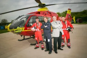 Maac Air Ambulance Crew Standing In Front Of A Helicopter