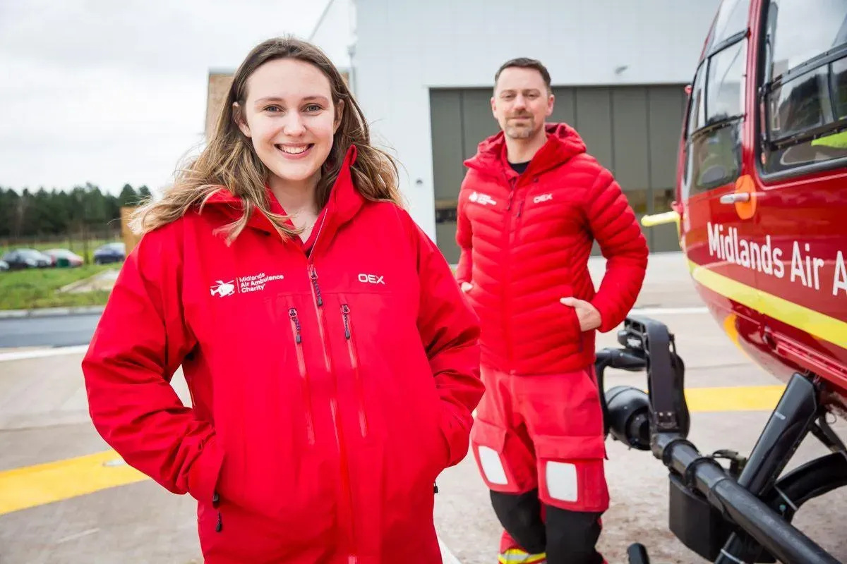 Maac Air Ambulance Crew Standing Next To A Helicopter
