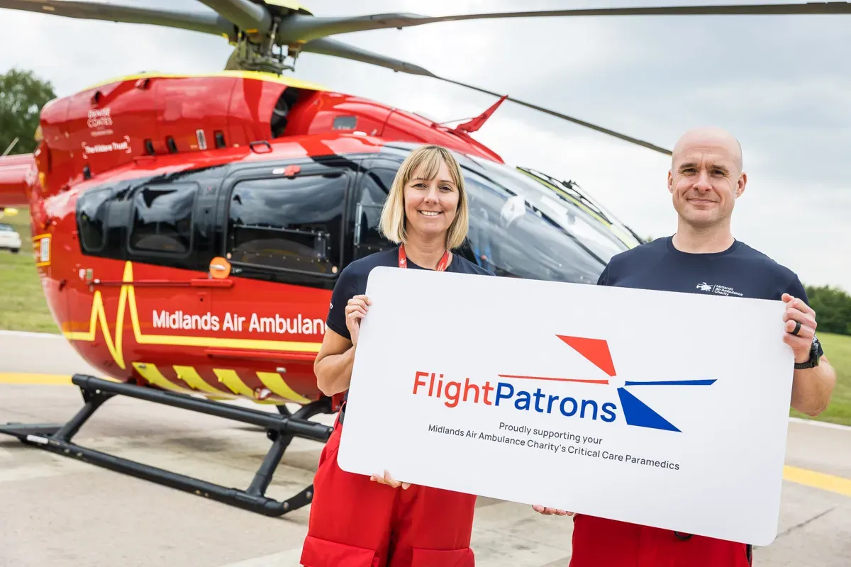 Maac Air Ambulance Helicopter With A Man And Woman Holding A Sign