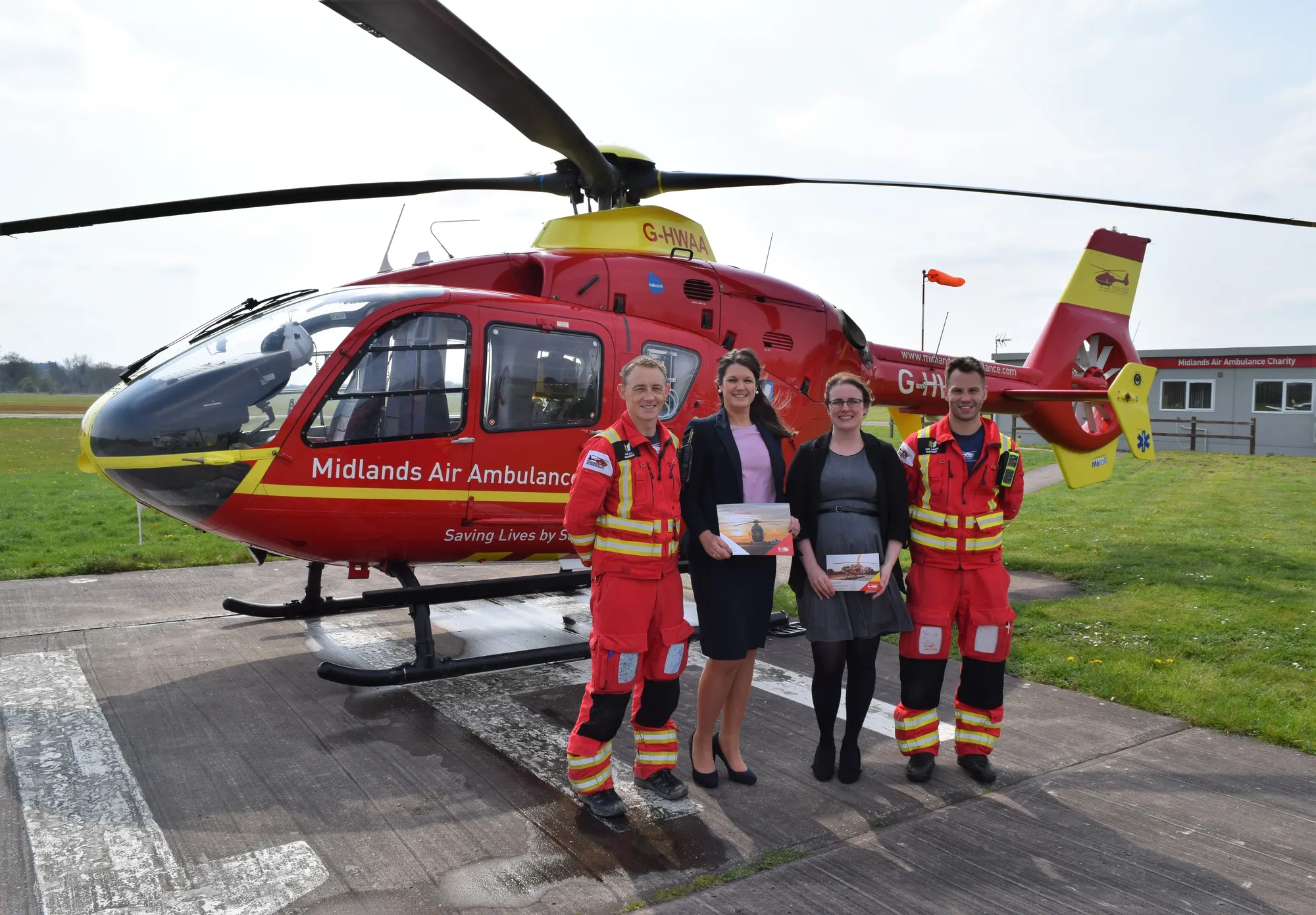 Maac Air Ambulance Team Standing In Front Of A Helicopter