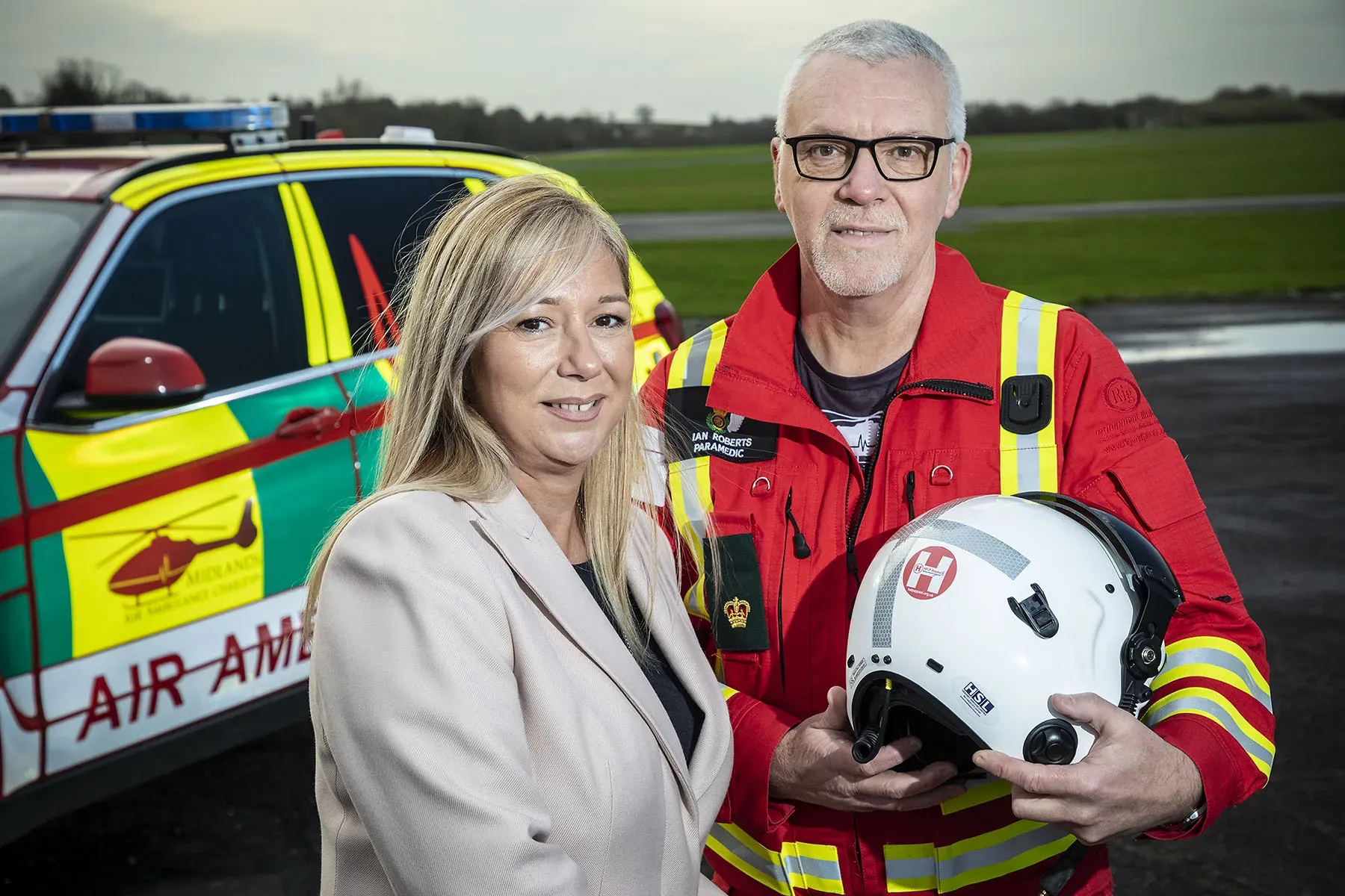 Maac Blond Woman Holding A Helmet And A Man In A Firefighter Uniform