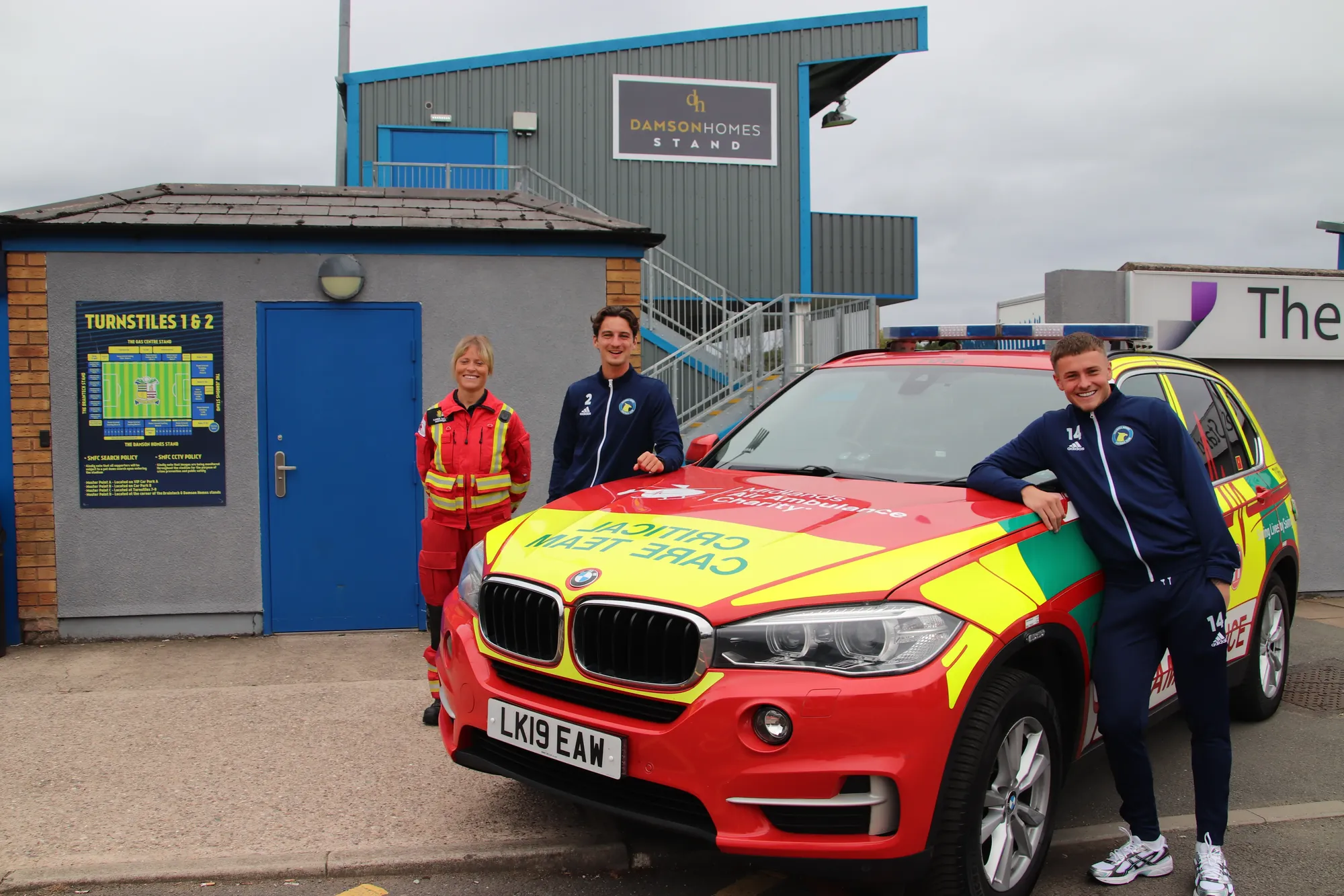 Maac Bmw Suv With A Man And Woman Standing Next To It