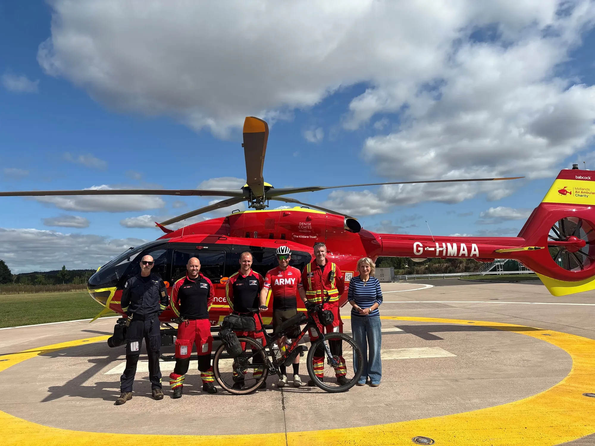 Maac Crew Of People Standing In Front Of A Helicopter