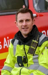 Maac Firefighter Sitting In Front Of A Fire Truck
