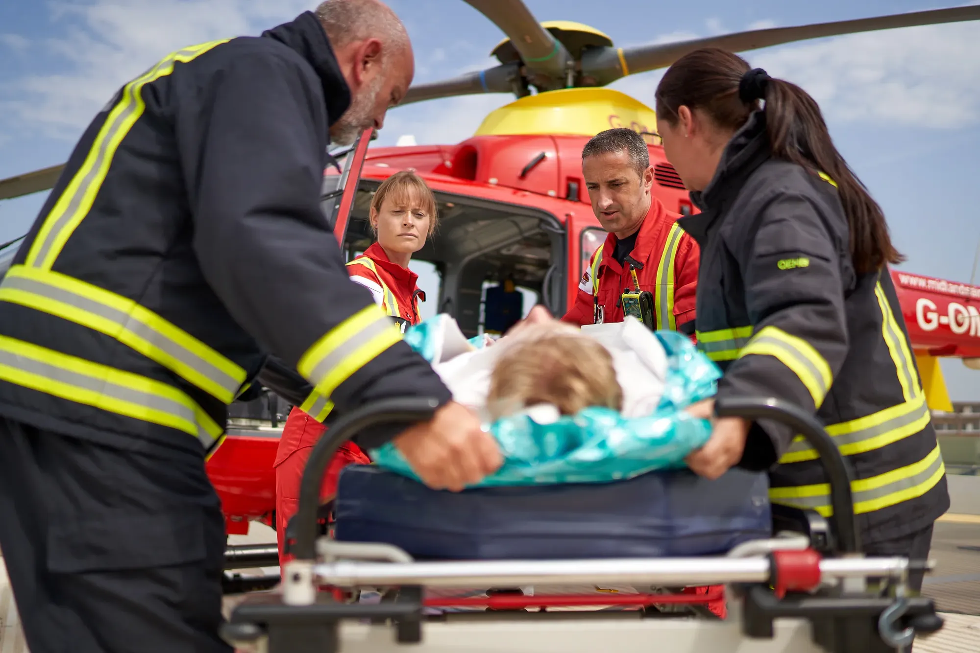 Maac Firefighters And Parameds Loading A Patient Onto A Helicopter