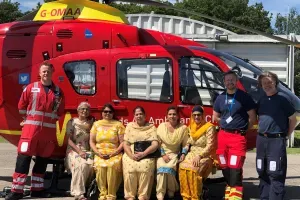 Maac Firefighters And Parameds Pose In Front Of A Helicopter