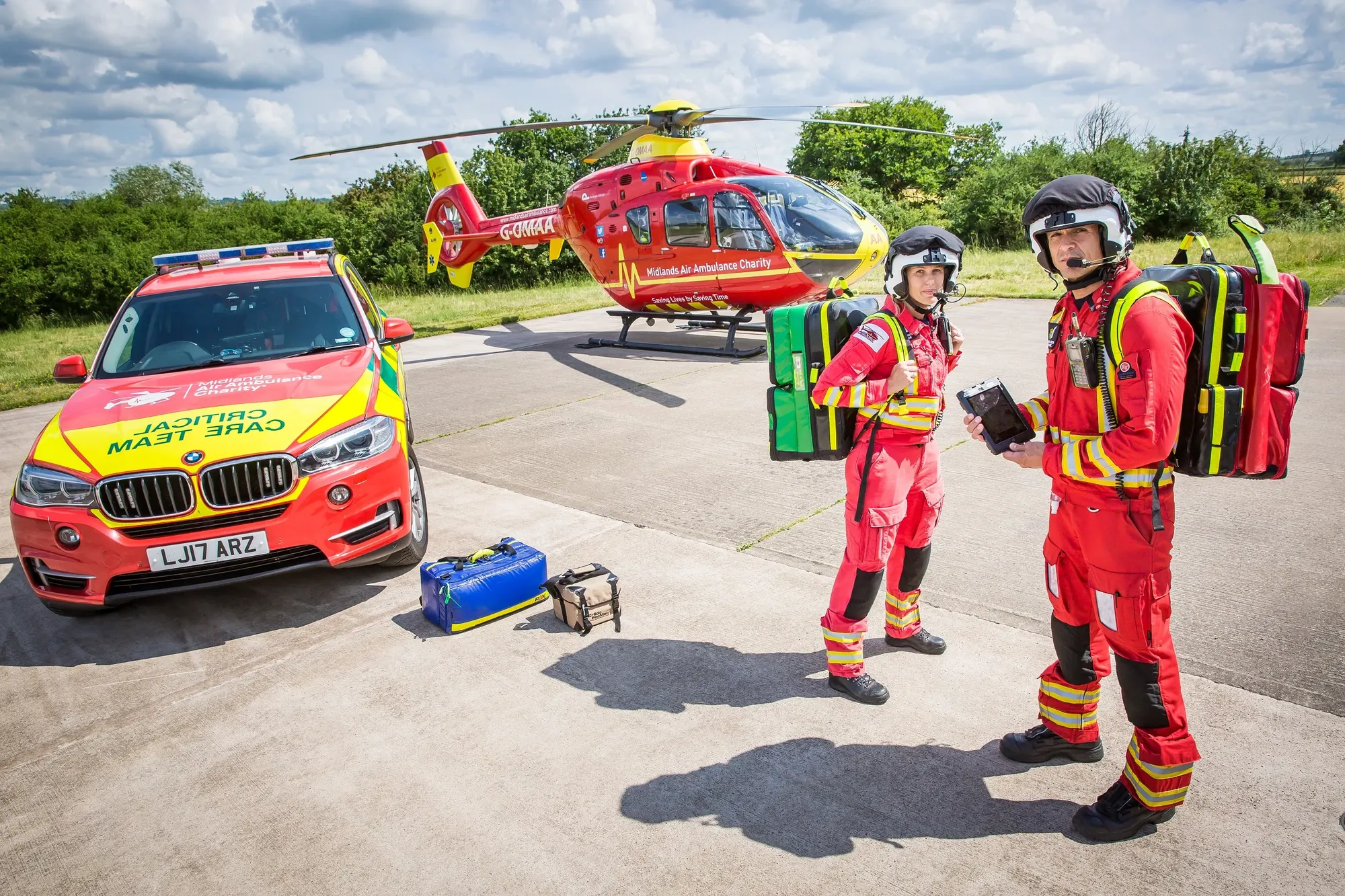 Maac Firefighters Standing In Front Of A Car And A Helicopter