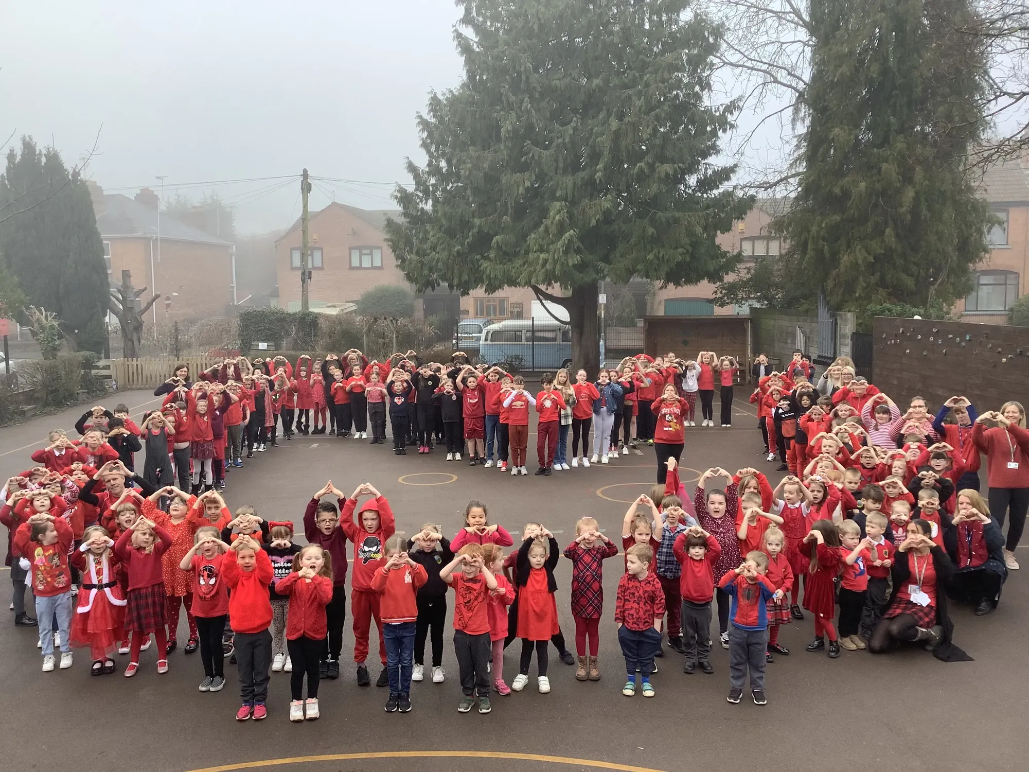 Maac Group Of Children In Red Shirts Standing In A Circle