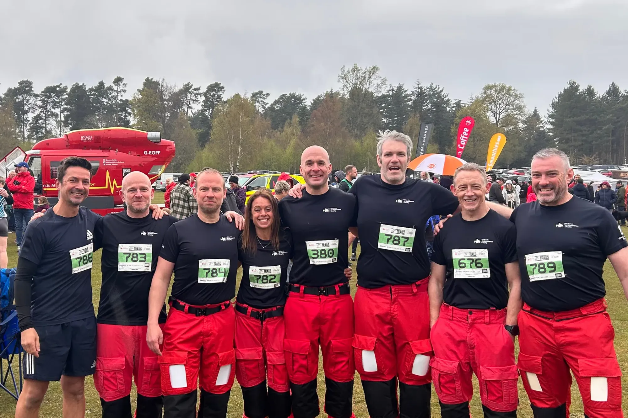 Maac Group Of People In Red And Black Shirts Posing For A Picture