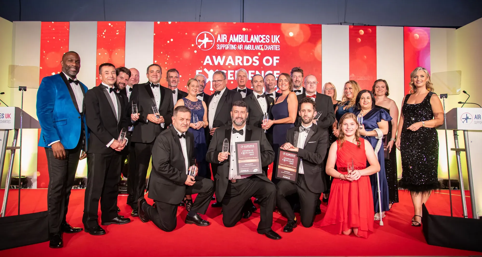 Maac Group Of People Posing For A Photo On A Red Carpet