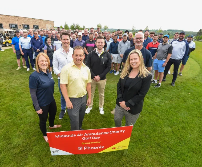 Maac Group Of People Standing In A Field With A Sign