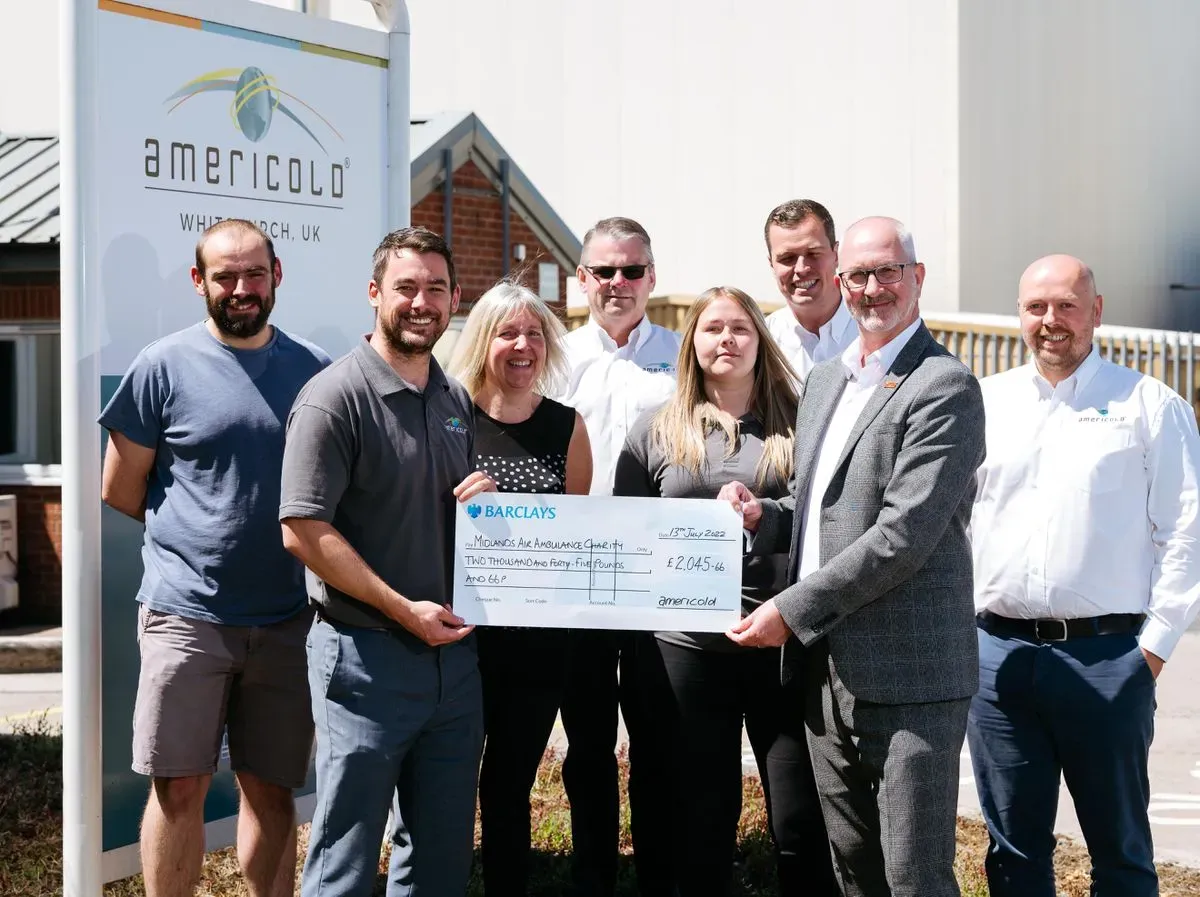 Maac Group Of People Standing In Front Of A Building Holding A Check