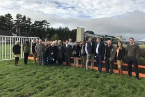 Maac Group Of People Standing In Front Of A Fence