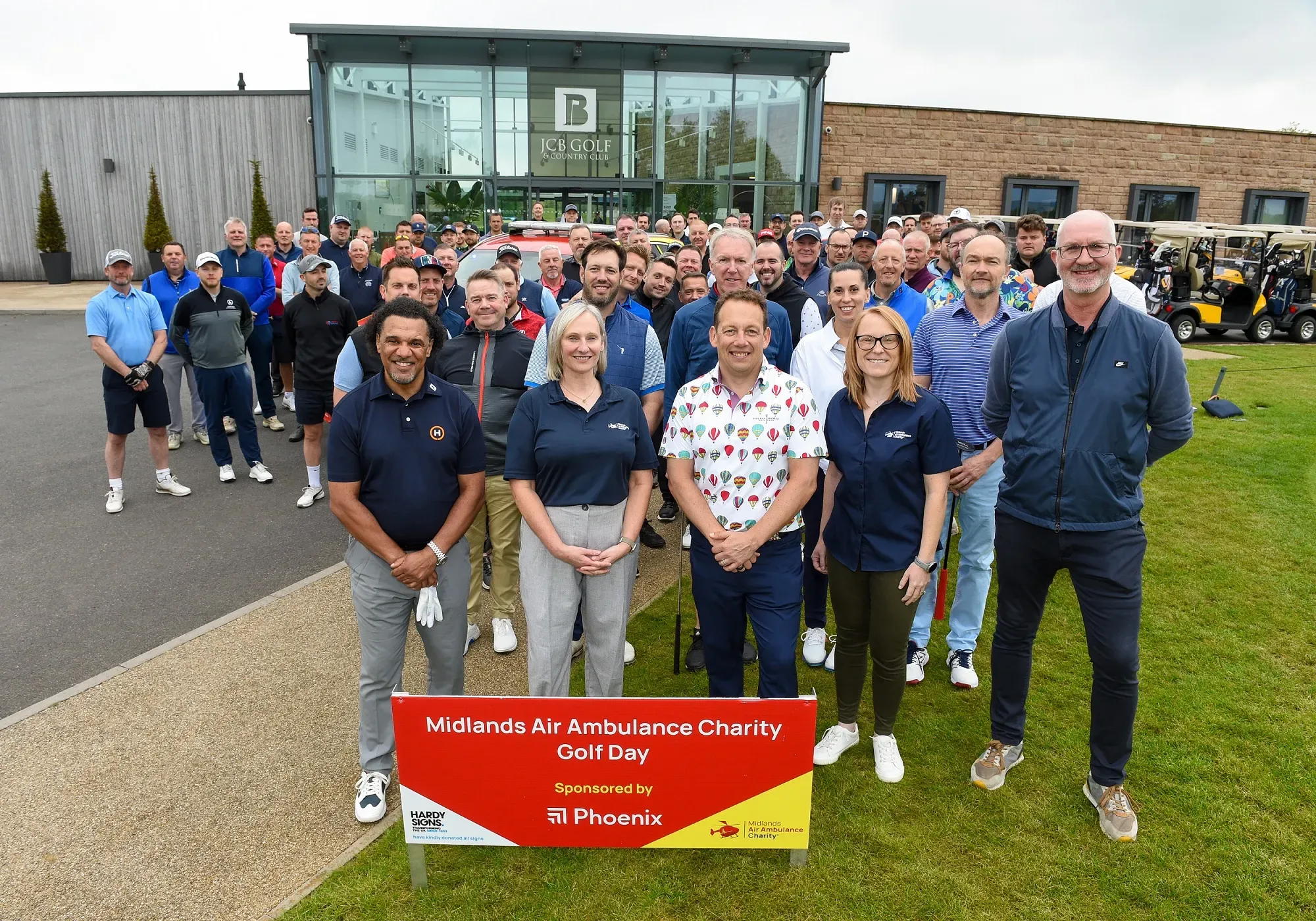 Maac Group Of People Standing In Front Of A Golf Course