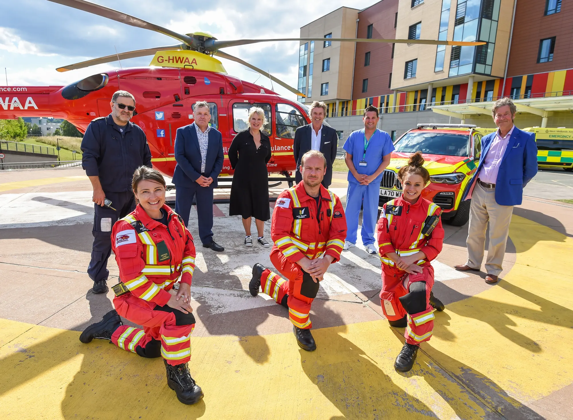 Maac Group Of People Standing In Front Of A Helicopter