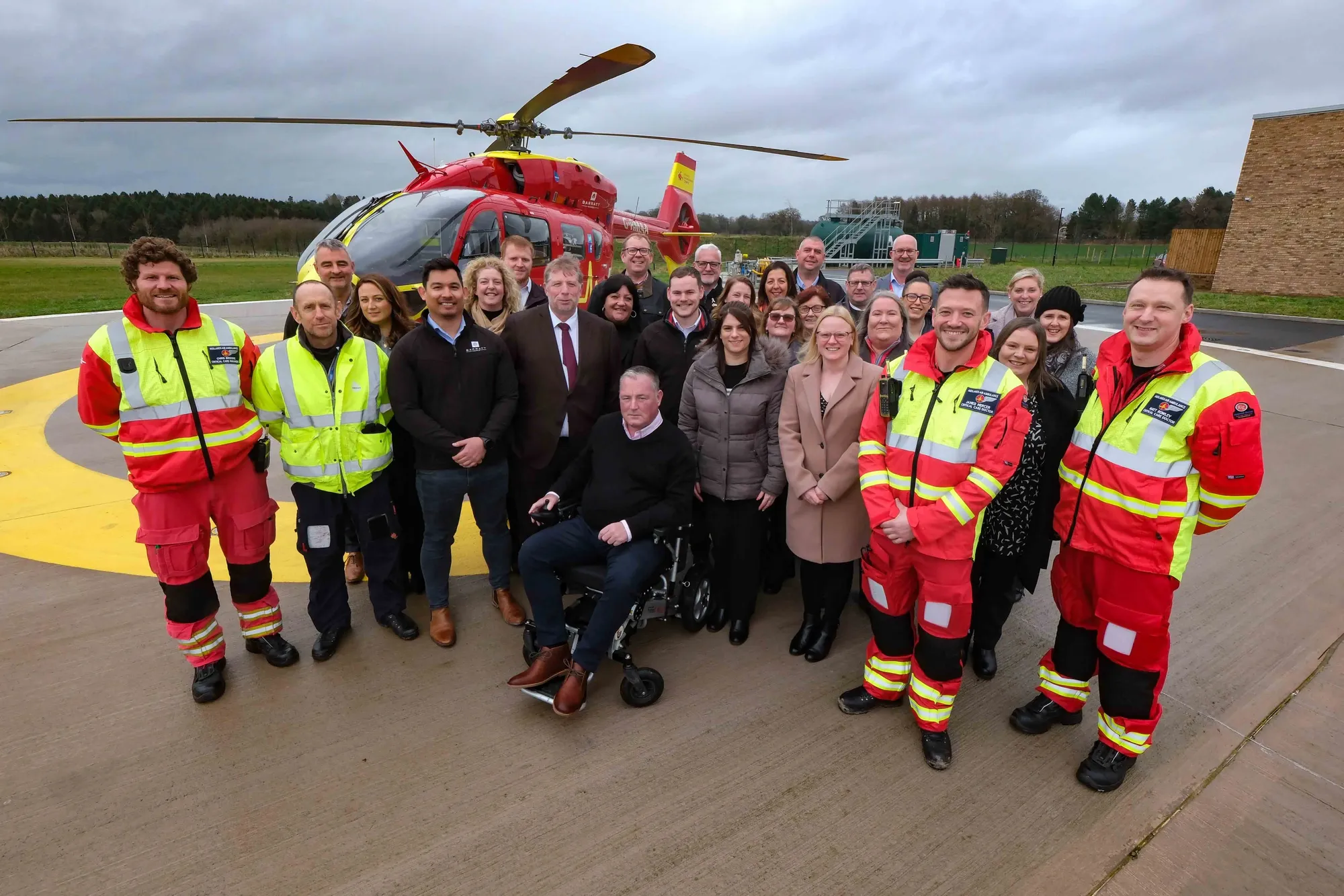 Maac Group Of People Standing In Front Of A Helicopter