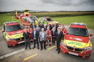 Maac Group Of People Standing In Front Of A Red And Yellow Ambulance