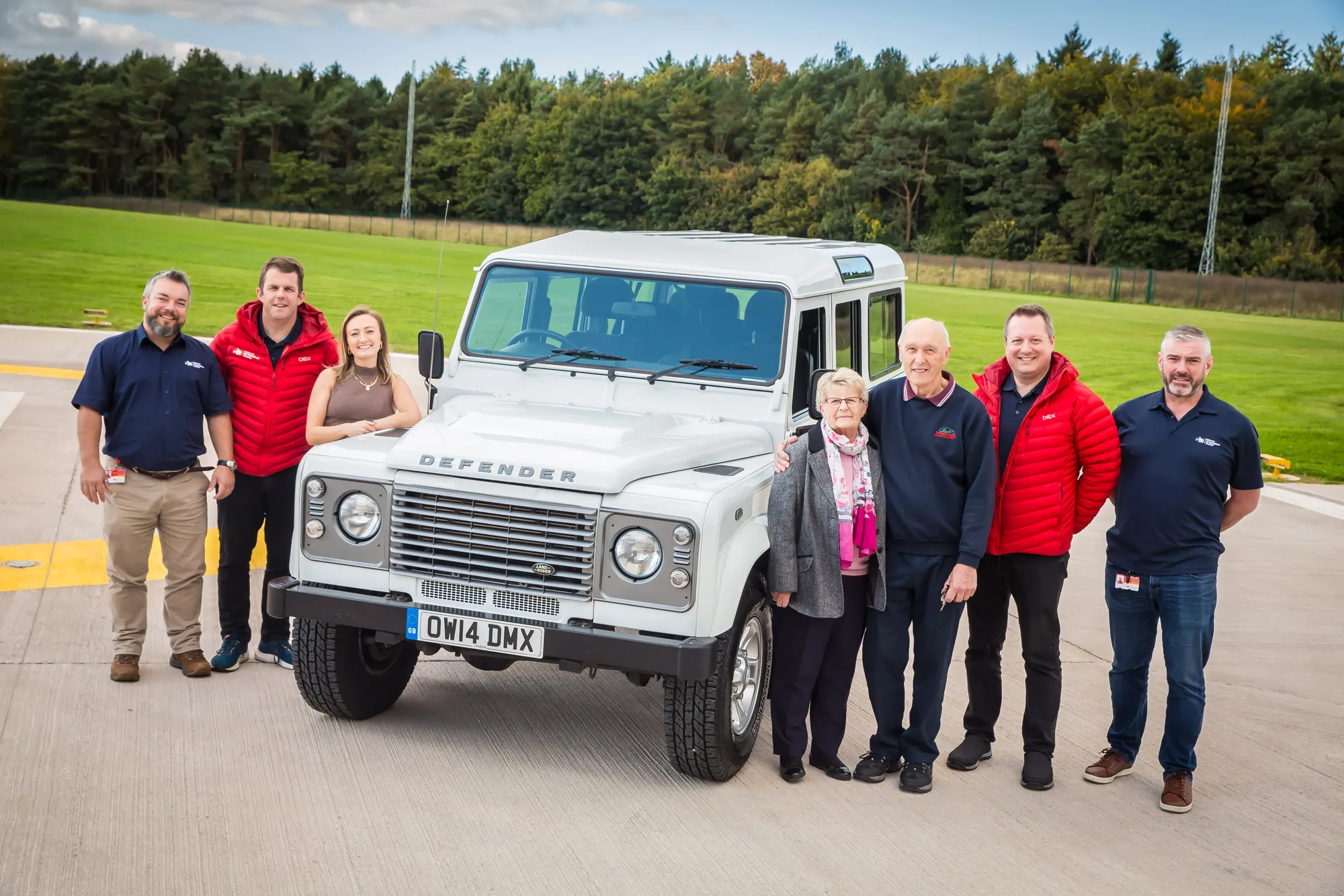 Maac Group Of People Standing In Front Of A White Truck