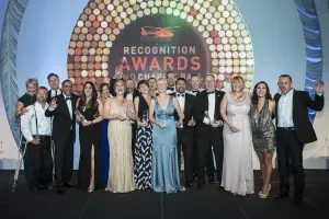 Maac Group Of People Standing On Stage Holding Awards