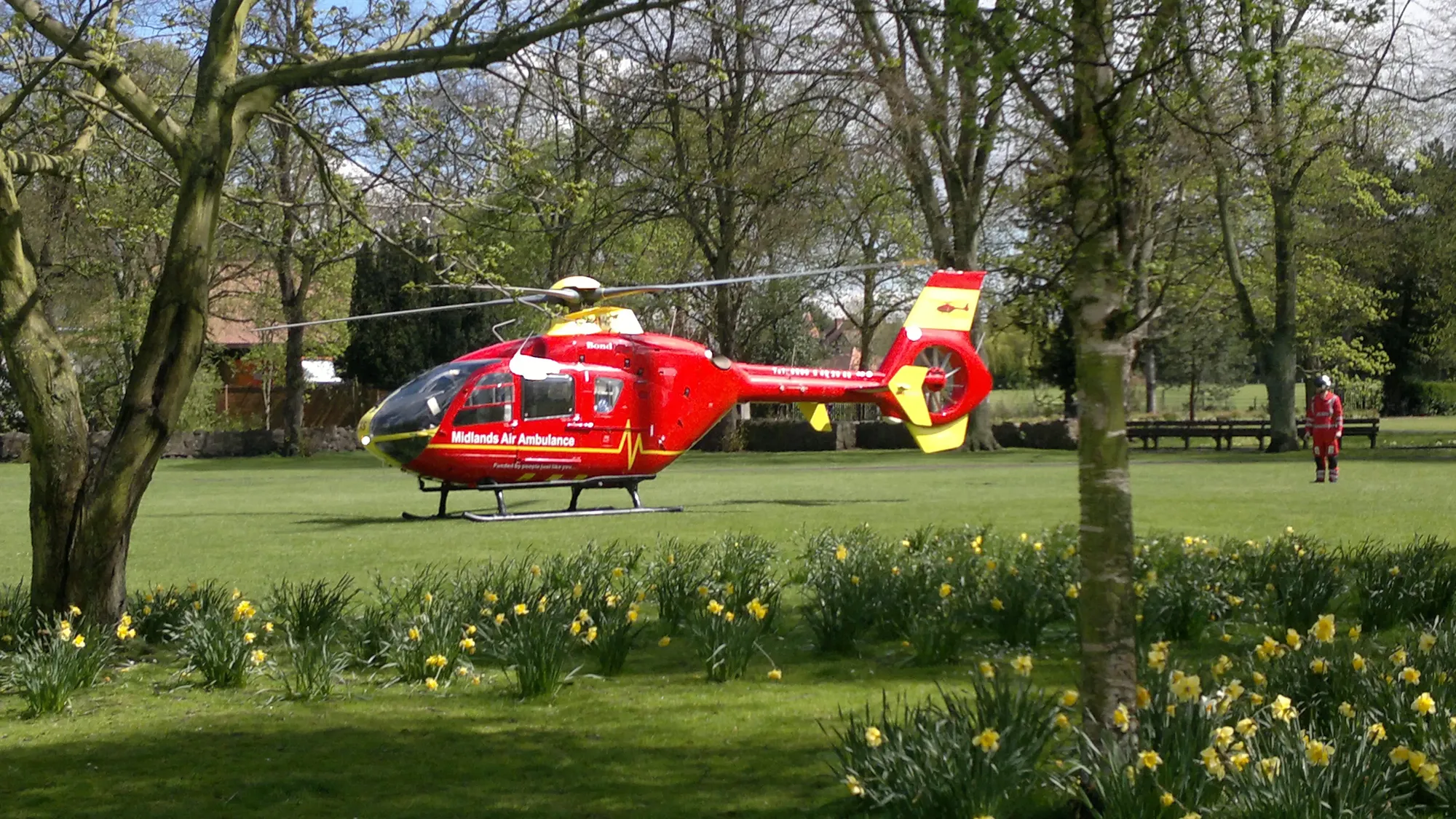 Maac Helicopter On The Grass With People In The Background