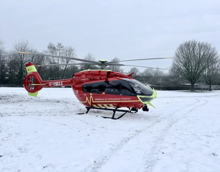 Maac Helicopter On The Ground With A Person Standing Next To It