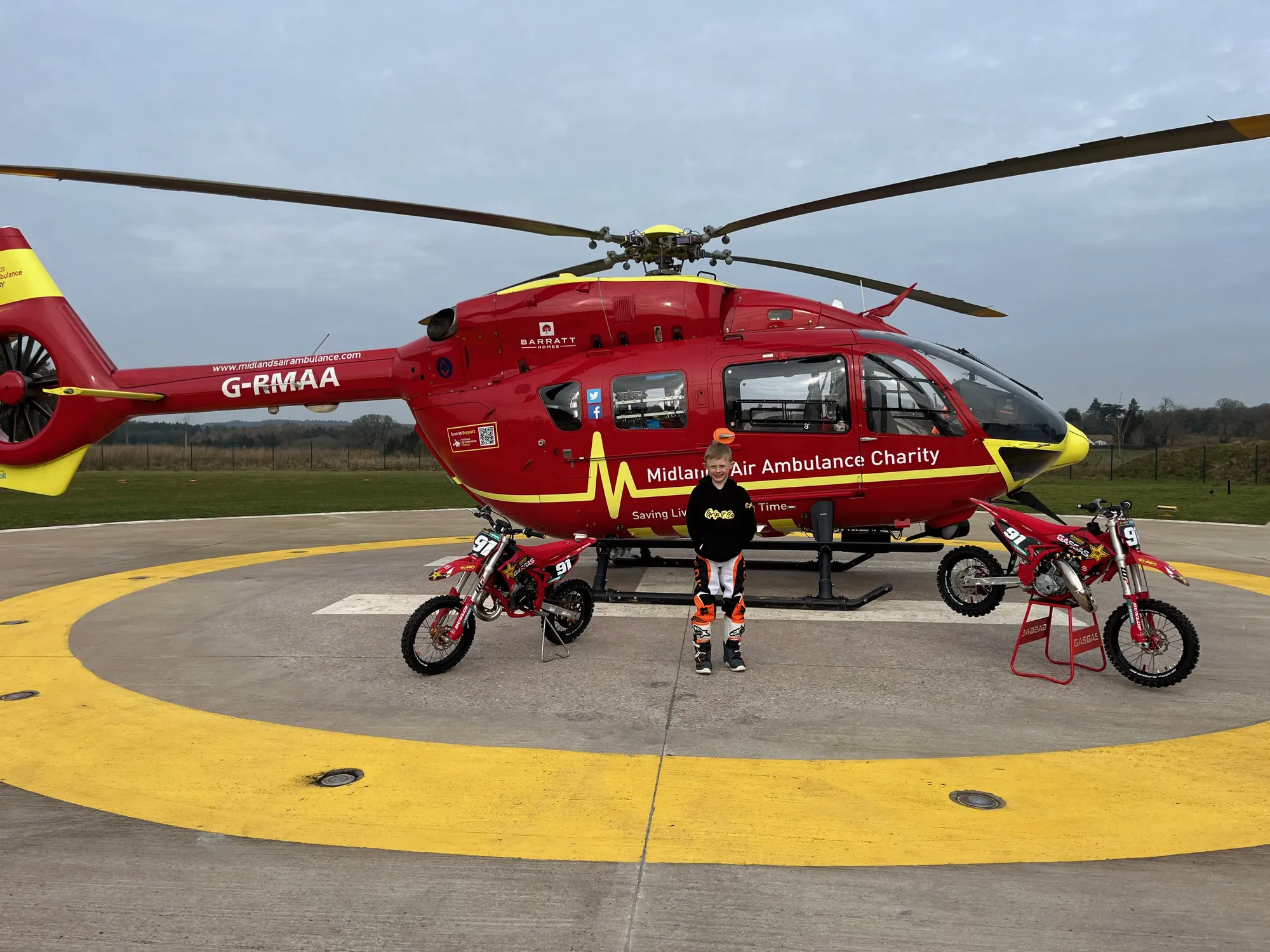 Maac Helicopter With A Person Standing Next To It On A Runway