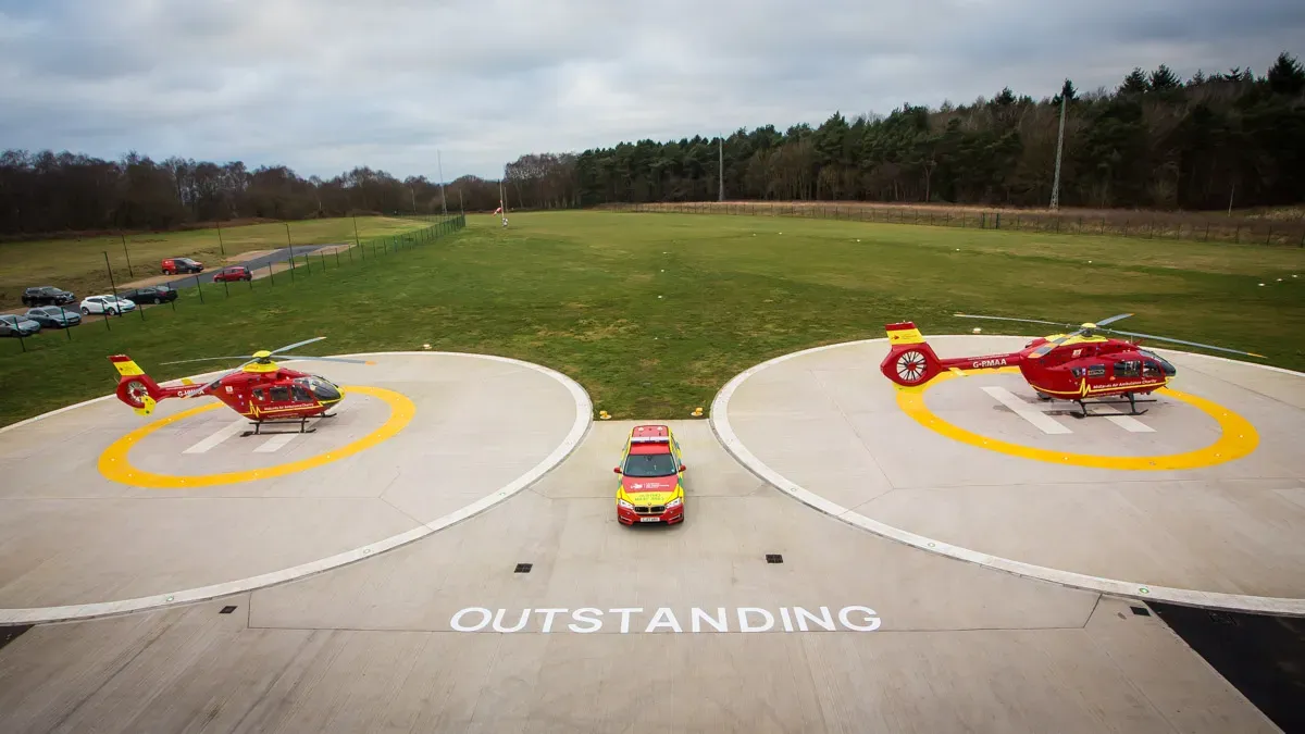 Maac Helicopters Are Parked On A Runway With A Car In The Foreground