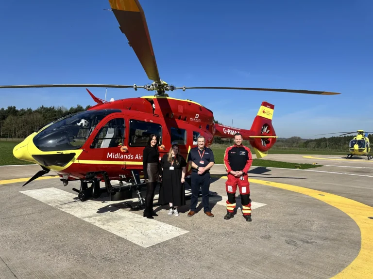 Maac Maac Rescue Team Standing In Front Of A Helicopter On A Runway Rescue Team Standing In Front Of A Helicopter On A Runway