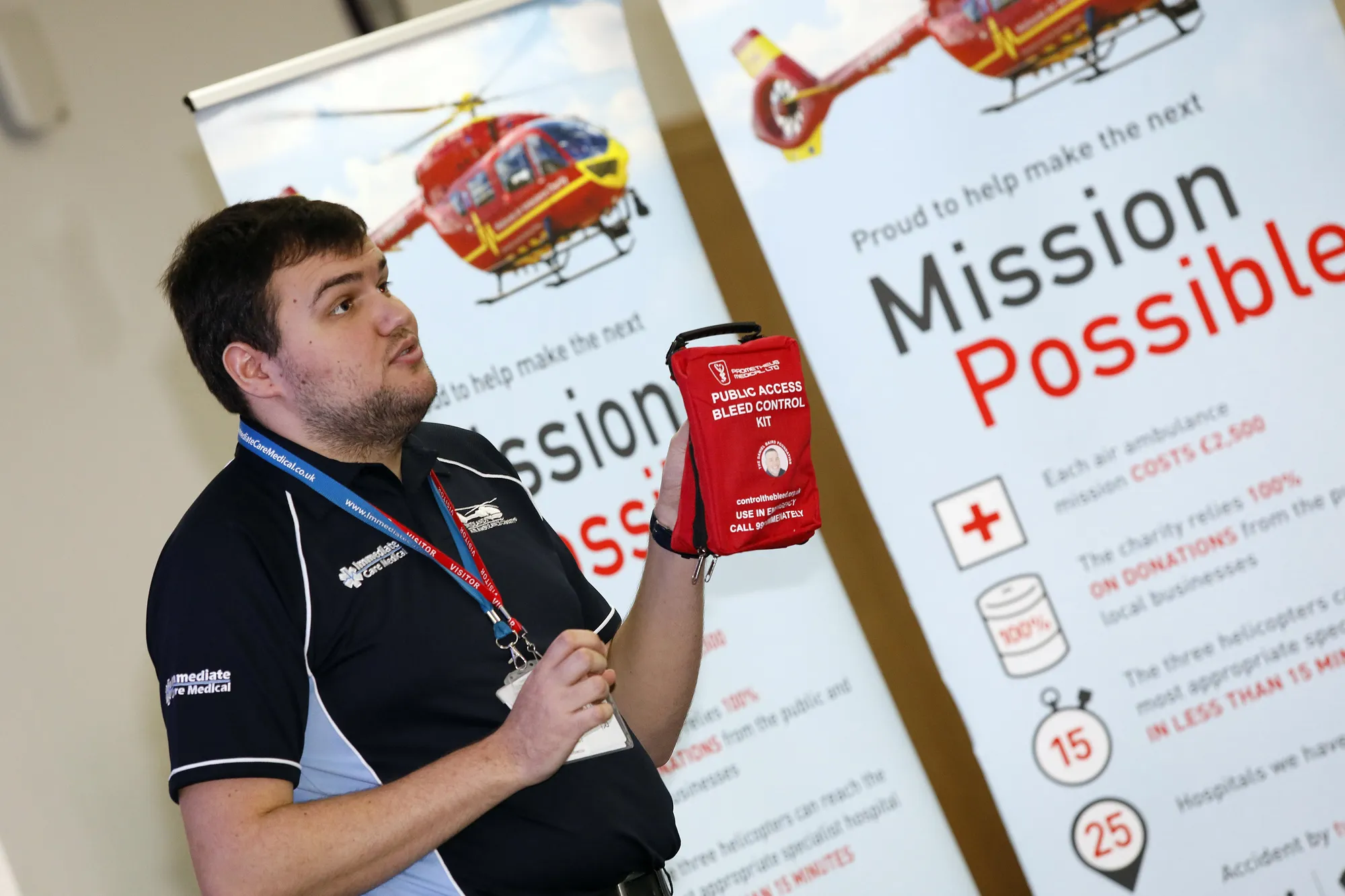 Maac Man Holding A Can Of Red Cross In Front Of A Sign